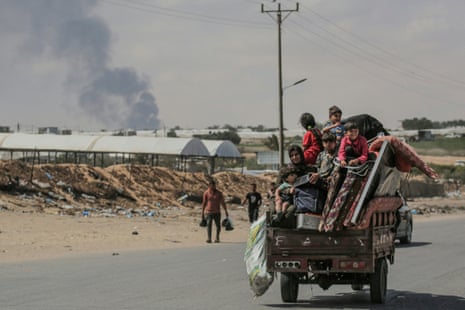 Palestinians fleeing with their belongings ride atop their vehicle in Rafah in the southern Gaza Strip on Wednesday.